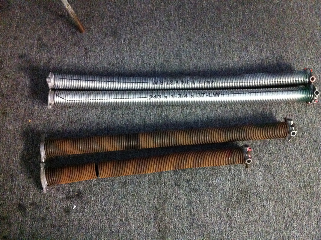 A pair of standard cycle oil tempered torsion springs next to a pair of high cycle galvanized torsion springs2